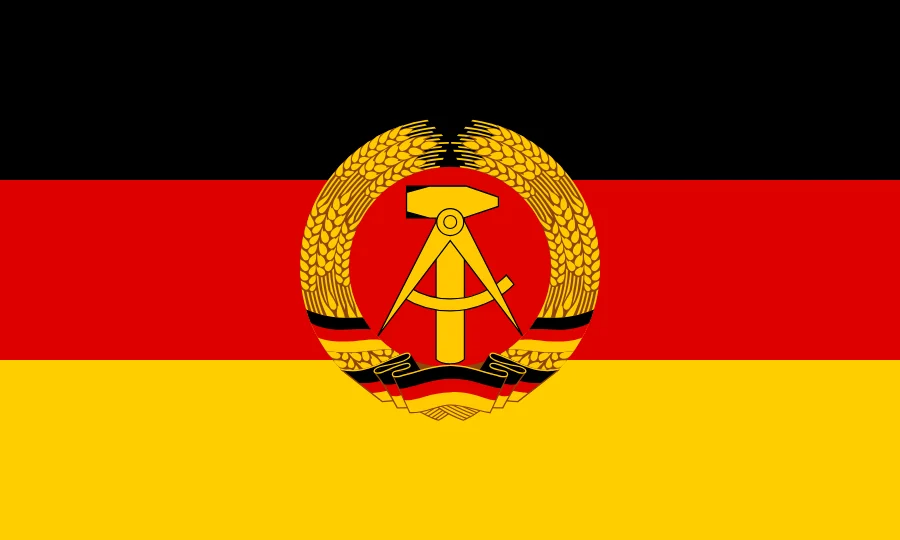 Flag of East Germany: black, red and gold with the state emblem in the centre